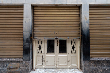 Obraz na płótnie Canvas Half Closed Shop Doors in Arabic Country. Tunisia.