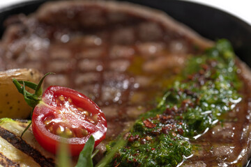 close-up of cooked steak with potatoes and vegetables
