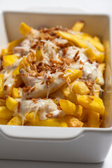 close-up of potatoes with meat sauce in a white bowl