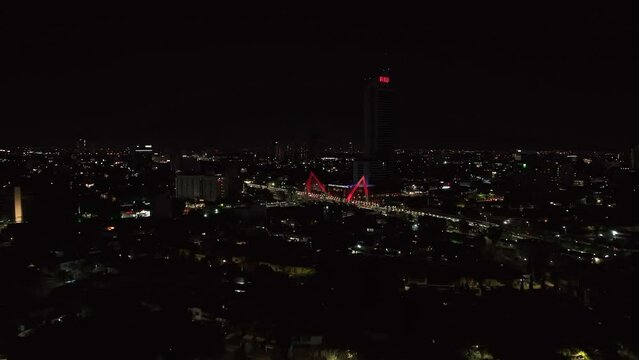 Distant Aerial View Of Matute Remus Bridge (Puente Matute Remus) Illuminated At Night In Guadalajara, Mexico.