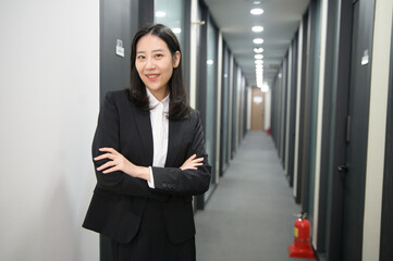 Portrait of successful asian young businesswoman working in her office