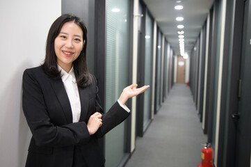 Portrait of successful asian young businesswoman working in her office