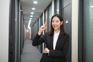 Portrait of successful asian young businesswoman working in her office