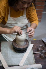 Hand close up of Young Asian female in the pottery workshop 
