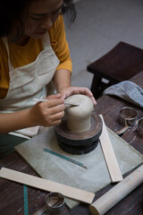 Hand close up of Young Asian female in the pottery workshop 