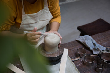 Hand close up of Young Asian female in the pottery workshop 