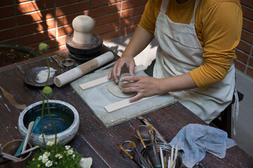 Hand close up of Young Asian female in the pottery workshop 
