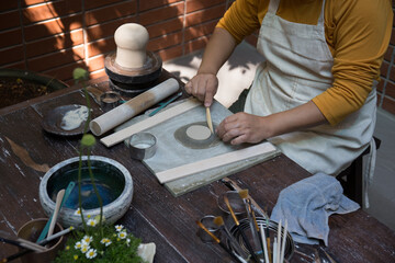 Hand close up of Young Asian female in the pottery workshop 