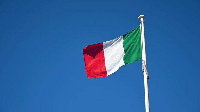 Italian flag on the pole. Green, white and red colors on flag of Italy.