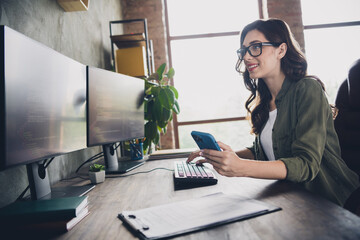 Profile photo of cheerful company ceo lady sitting chair keyboard typing hold telephone coworking...