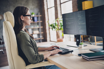Photo of intelligent clever lady programmer wear glasses writing code modern device indoors...
