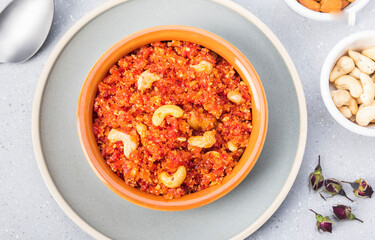 Gajar ka halwa is, Popular Indian dessert pudding made with grated carrots, milk, sugar and nuts served hot with a garnish of almonds, cashew nuts and pistachios.
