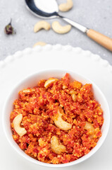 Gajar ka halva is a traditional North Indian dessert made with freshly grated carrots, desi ghee, milk and sugar, delicately scented with cardamom and garnished with chopped nuts.
