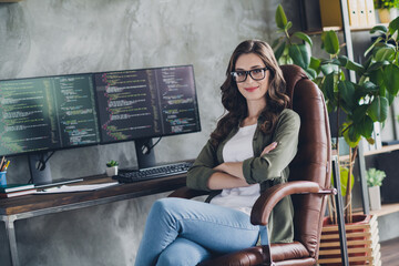 Photo of smart positive pretty lady sitting leather chair crossed hands server optimization open...