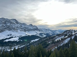 Late evening winter sun over the snow-covered slopes of the Alpstein mountain range and before dusk over massif of the Swiss Alps, Urnäsch (Urnaesch or Urnasch) - Canton of Appenzell, Switzerland