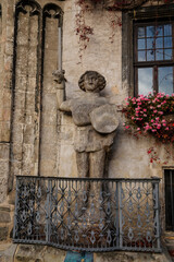 Quedlinburg, Saxony-Anhalt, Germany, 28 October 2022: Historic gothic townhall or Rathaus with Roland statue in Market Square, vintage colored timber frame houses in medieval town at sunny autumn day