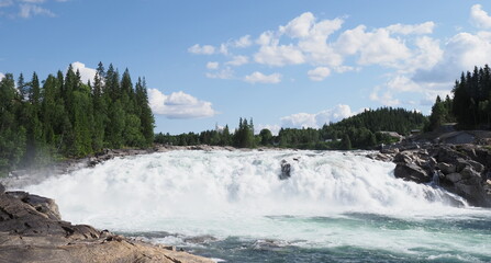 Scenic Laksforsen waterfall at Vefsna river in Grane town in Norway