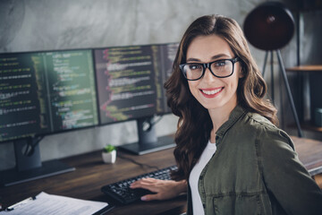 Portrait of cheerful intelligent manager lady toothy smile operating pc typing code workstation...