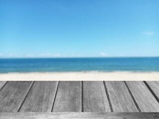 Naklejka na ściany i meble empty deck table top and blur tropical beach and blue sky nature of the background graphic illustration 