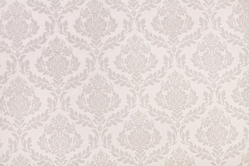 Victorian styled wallpaper texture. Beige tones and floral patterns.