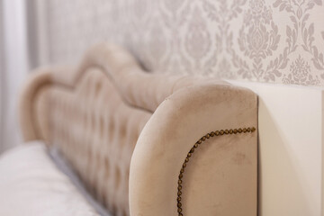 Padded headboard in Louis XV style with pastel tones.
