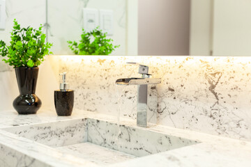 Luxurious bathroom decorated with marble, tub and stylish faucet.