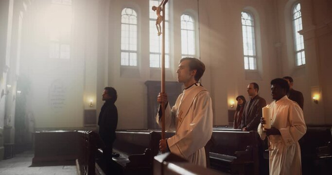 Liturgy in Grand Church: Majestic Procession Of Ministers And Priests Walking with Processional Cross. Congregation Stands In Reverence, Christians Rejoice In Ceremony of Mass. Slow Motion Pan Shot
