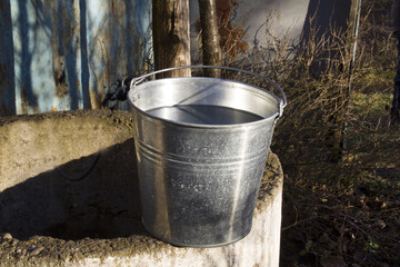 Rural well with a filled bucket of water