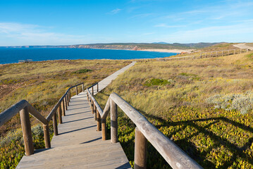 coastal hiking trail Carrapateira, wooden boardwalk to the beach Bordeira. Portugal landscape