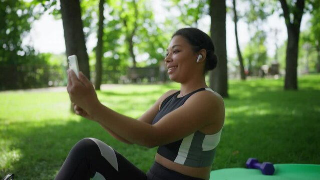 African American woman having online video call with a friend after workout