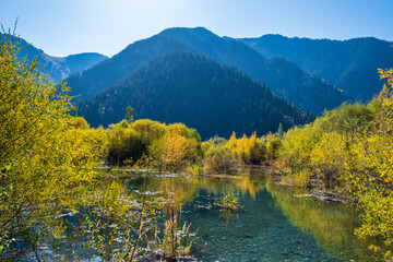 autumn landscape with lake and mountains