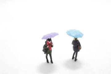 a figure lady wearing raincoat and umbrella,