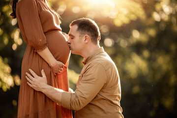 Couple in the park,close up of pregnant woman