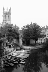 Oxford Magdalen tower and canal with wooden boats black and white