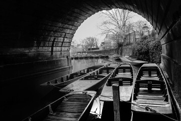 Parked boats under bridge nice stone arch - black and white