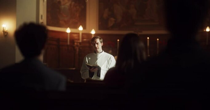 In Christian Church: Portrait of Minister Leading Congregation In Prayer, Reads From Holy Book, The Bible, Gospel of Jesus. Priest Providing Guidance, Belief, Hope, Faith to People. Cinematic Light