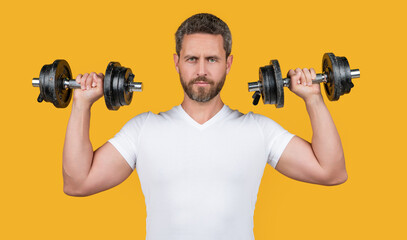 Fototapeta na wymiar strong muscular fitness guy hold barbell in shirt. muscular fitness guy with barbell.