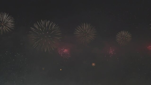 Colorful huge fireworks. Beautiful holiday fireworks in slow motion. Wonderful real fireworks in the night sky. Fireworks show. 4K slow motion 120 fps video, ProRes 422, 10 bit ungraded C-LOG