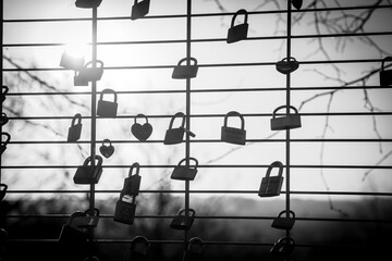 love locker locked to a fence in black and white