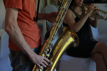 Person playing big saxophone instrument close up
