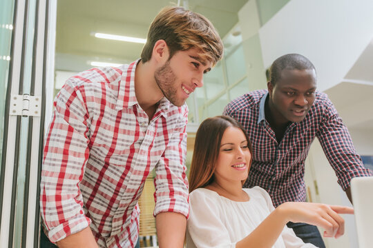 Young Entrepreneurs Working at the Office and Checking a Project on Screen