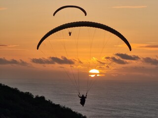 paraglider silhouette on sunset