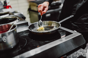 chef frying butter in pan at kitchen