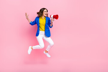 Full body portrait of crazy overjoyed lady jumping hold loudspeaker empty space isolated on pink...