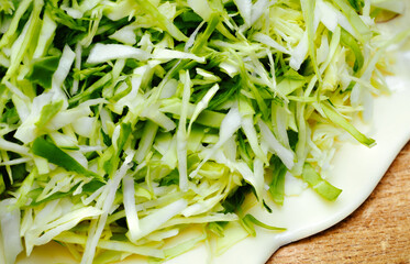 Chopped  Cabbage, Cabbage, or Wombok Isolated on a wood Background. Fresh Green Sliced Cabbage Salat Top View, Composition with cut cabbage on a wooden table