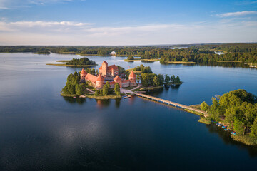 Trakai Castle with lake and forest in background. Lithuania. - obrazy, fototapety, plakaty