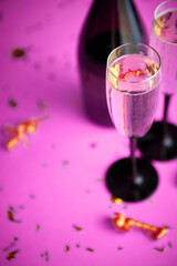 Two glasses full of sparkling champagne wine with golden decoration