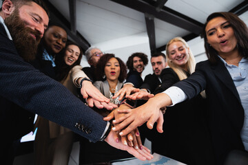 Multiracial mixed group of colleagues join hands together. Unity and teamwork concept.