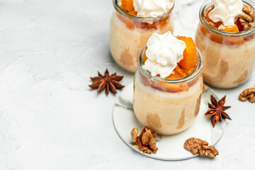Layered pumpkin and cream cheese dessert on a light background. banner, menu, recipe place for text, top view