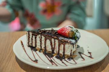 close-up of a cake with strawberries on a plate in a cafe
